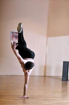 young man performing break dance in dance studio