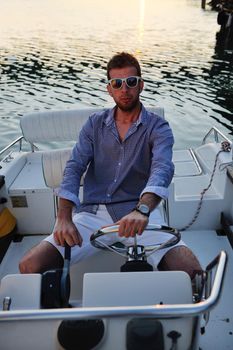 happy young man have fun at boat at sunset on summer season