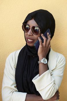 african  business woman using smart phone wearing traditional islamic clothes