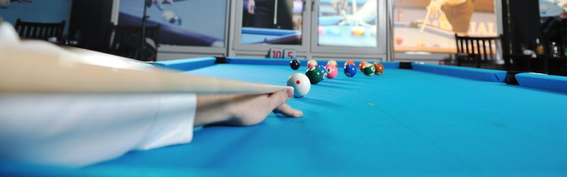 young pro billiard player finding best solution and right angle at billard or snooker pool sport  game 