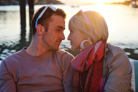 happy young couple in love  have romantic time at summer sunset   at ship boat while  representing urban and countryside fashin lifestyle