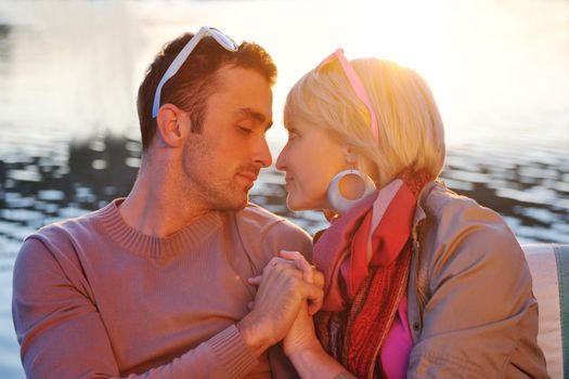 happy young couple in love  have romantic time at summer sunset   at ship boat while  representing urban and countryside fashin lifestyle