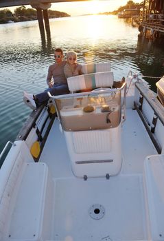 happy young couple in love  have romantic time at summer sunset   at ship boat while  representing urban and countryside fashin lifestyle