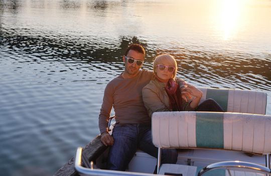 happy young couple in love  have romantic time at summer sunset   at ship boat while  representing urban and countryside fashin lifestyle