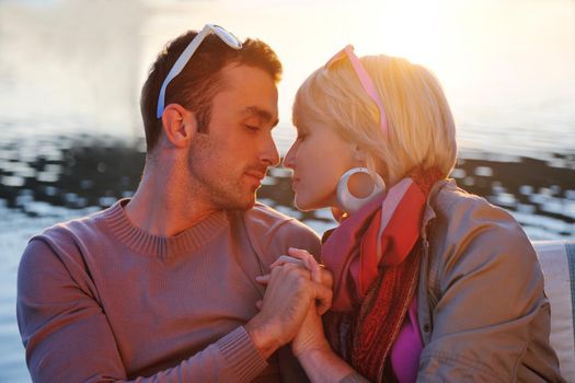 happy young couple in love  have romantic time at summer sunset   at ship boat while  representing urban and countryside fashin lifestyle