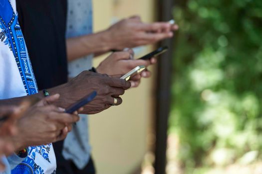 multiethnic students group on break using smart phones