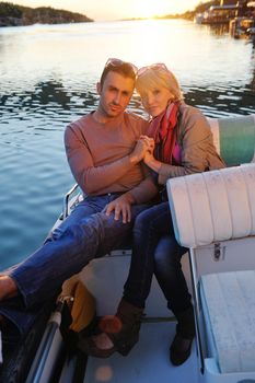 happy young couple in love  have romantic time at summer sunset   at ship boat while  representing urban and countryside fashin lifestyle