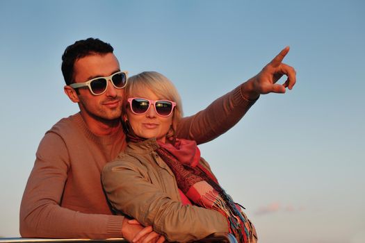 happy young couple in love  have romantic time at summer sunset   at ship boat while  representing urban and countryside fashin lifestyle