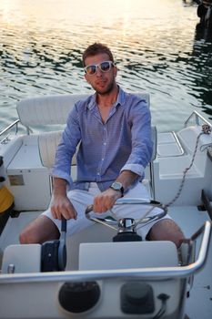 happy young man have fun at boat at sunset on summer season