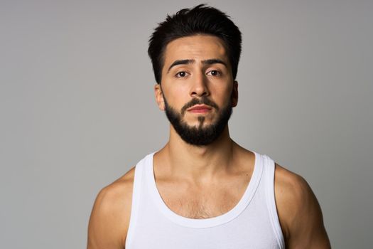 bearded man in white tank top cropped view Studio Model. High quality photo