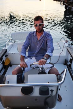 happy young man have fun at boat at sunset on summer season