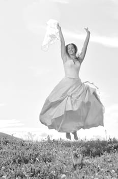 happy young beautiful bride after wedding ceremony event have fun outdoor on meadow at sunset