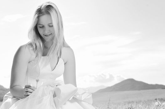 happy young beautiful bride after wedding ceremony event have fun outdoor on meadow at sunset