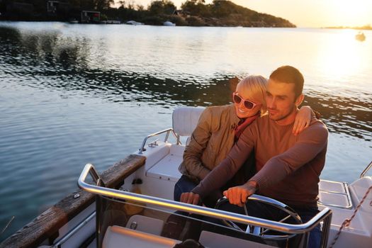 happy young couple in love  have romantic time at summer sunset   at ship boat while  representing urban and countryside fashin lifestyle