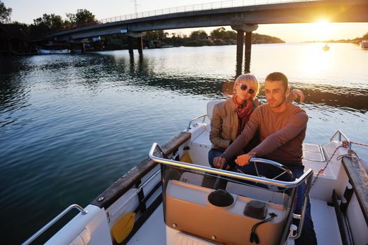 happy young couple in love  have romantic time at summer sunset   at ship boat while  representing urban and countryside fashin lifestyle