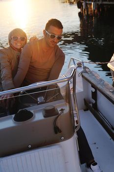 happy young couple in love  have romantic time at summer sunset   at ship boat while  representing urban and countryside fashin lifestyle