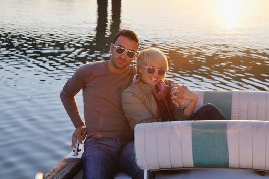 happy young couple in love  have romantic time at summer sunset   at ship boat while  representing urban and countryside fashin lifestyle