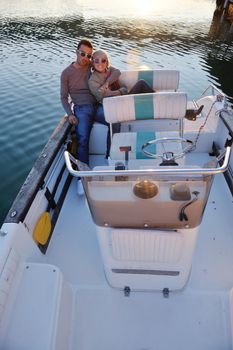 happy young couple in love  have romantic time at summer sunset   at ship boat while  representing urban and countryside fashin lifestyle