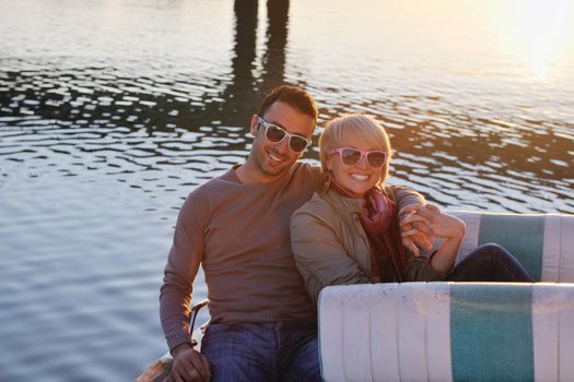 happy young couple in love  have romantic time at summer sunset   at ship boat while  representing urban and countryside fashin lifestyle