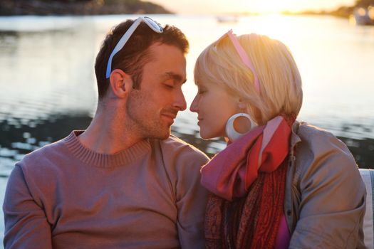 happy young couple in love  have romantic time at summer sunset   at ship boat while  representing urban and countryside fashin lifestyle