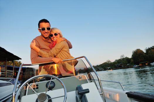 happy young couple in love  have romantic time at summer sunset   at ship boat while  representing urban and countryside fashin lifestyle