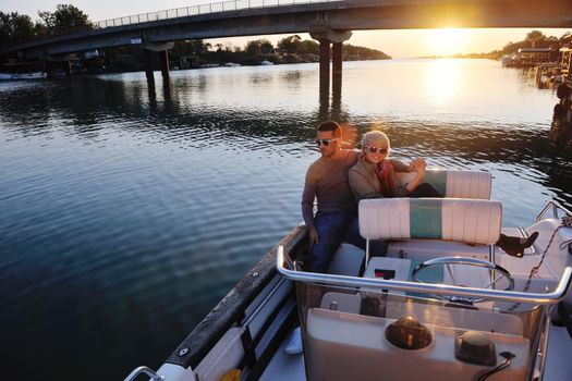 happy young couple in love  have romantic time at summer sunset   at ship boat while  representing urban and countryside fashin lifestyle