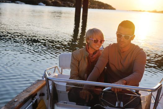 happy young couple in love  have romantic time at summer sunset   at ship boat while  representing urban and countryside fashin lifestyle