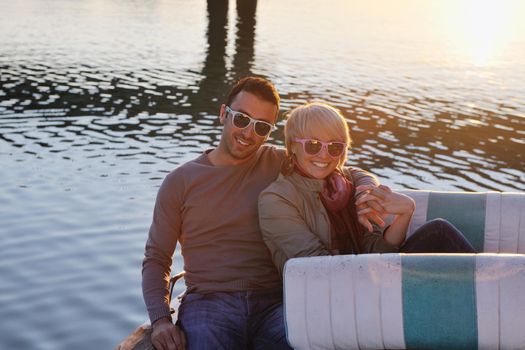 happy young couple in love  have romantic time at summer sunset   at ship boat while  representing urban and countryside fashin lifestyle