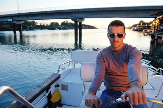 happy young man have fun at boat at sunset on summer season