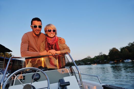 happy young couple in love  have romantic time at summer sunset   at ship boat while  representing urban and countryside fashin lifestyle