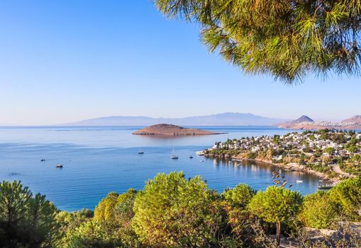 Aegean coast with marvelous blue water, rich nature, islands, mountains and small white houses