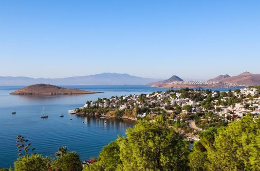 Aegean coastline with wonderful blue water, rich nature, islands, mountains and small white houses. Summer vacation concept.