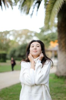 Portrait of asian nice girl walking outdoors. Concept of beauty and nature.