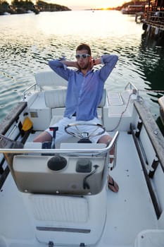 happy young man have fun at boat at sunset on summer season