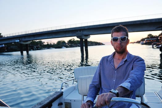 happy young man have fun at boat at sunset on summer season