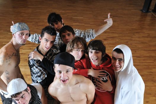 group of young happy boys posing  together in dence studio
