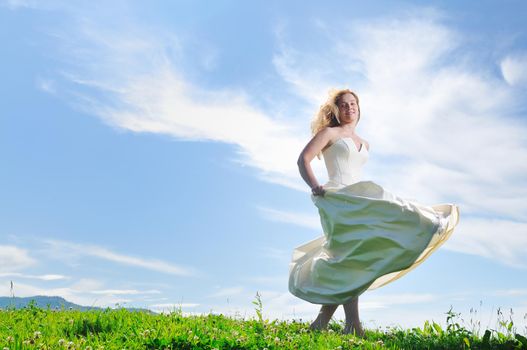 happy young beautiful bride after wedding ceremony event have fun outdoor on meadow at sunset