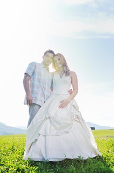 happy young beautiful bride after wedding ceremony event have fun outdoor on meadow at sunset with windmill toy and representing smart energy