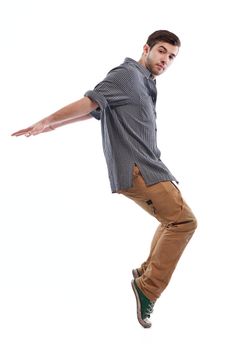 young boy man teen dancing and jumping isolated on white background in studio