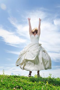 happy young beautiful bride after wedding ceremony event have fun outdoor on meadow at sunset