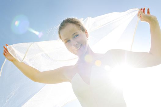 happy young beautiful bride after wedding ceremony event have fun outdoor on meadow at sunset