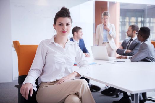 business woman with her staff, people group in background at modern bright office indoors