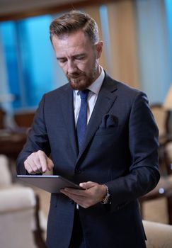 corporate business man using tablet computer in luxury office