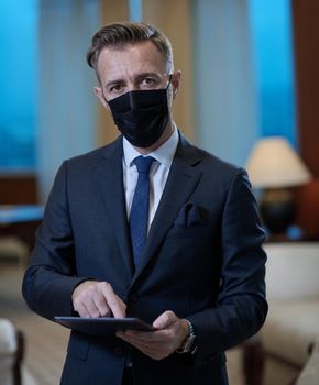 corporate business man wearing protective medical face mask at luxury office