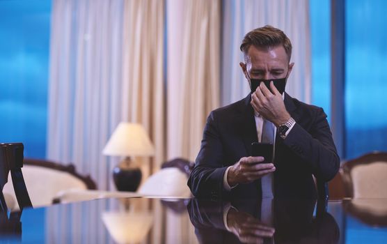 corporate business man wearing face mask and  using smart phone at luxury office