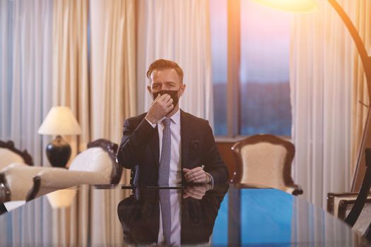 corporate business man wearing protective medical face mask at luxury office