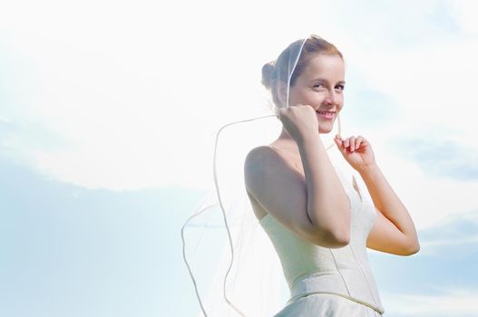 happy young beautiful bride after wedding ceremony event have fun outdoor on meadow at sunset