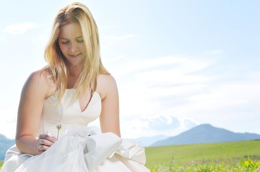 happy young beautiful bride after wedding ceremony event have fun outdoor on meadow at sunset