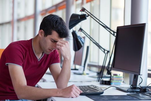 frustrated young business man working on laptop computer at office