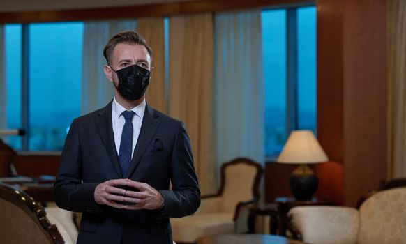 corporate business man wearing protective medical face mask at luxury office